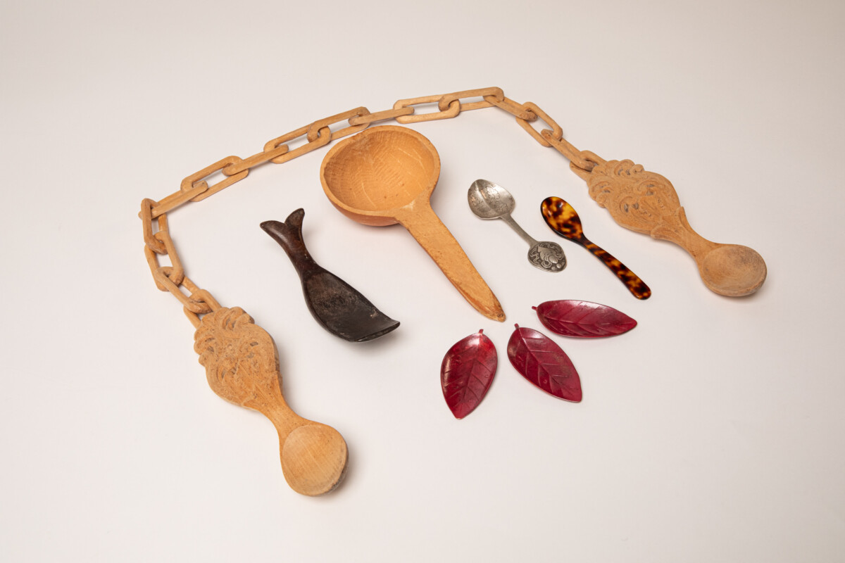 Collection of spoons made of various materials and styles laying on a table