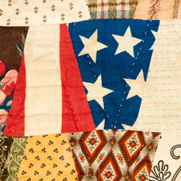 Image Description: Gently folded quilted textiles with patriotic motifs.