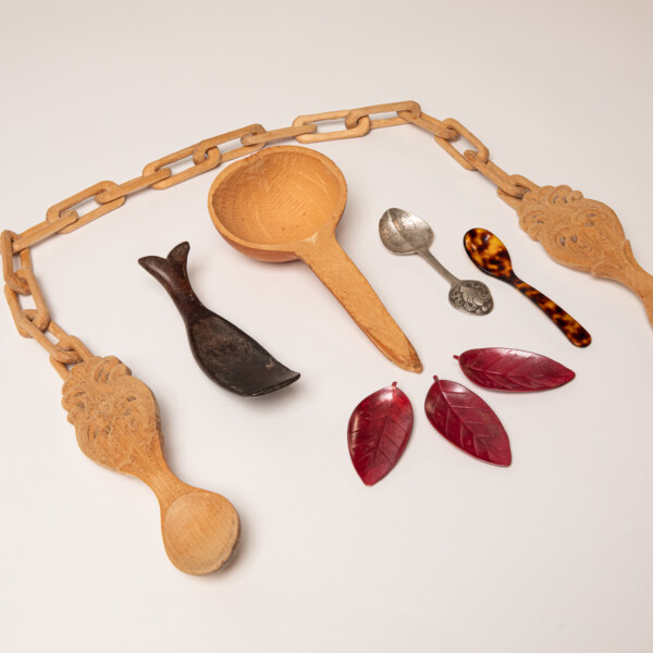 Collection of spoons made of various materials and styles laying on a table