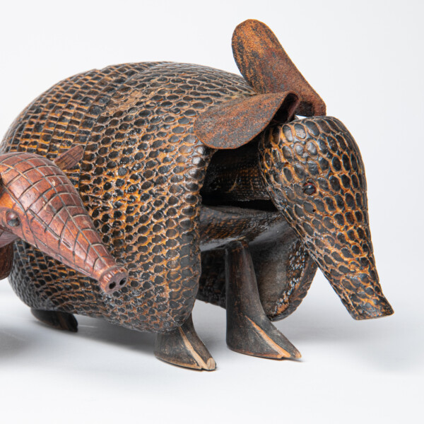 Two armadillo sculptures from Brazil. One made from a coconut shell, and the other carved from wood. 1993-55-035 and 1995-37-001.