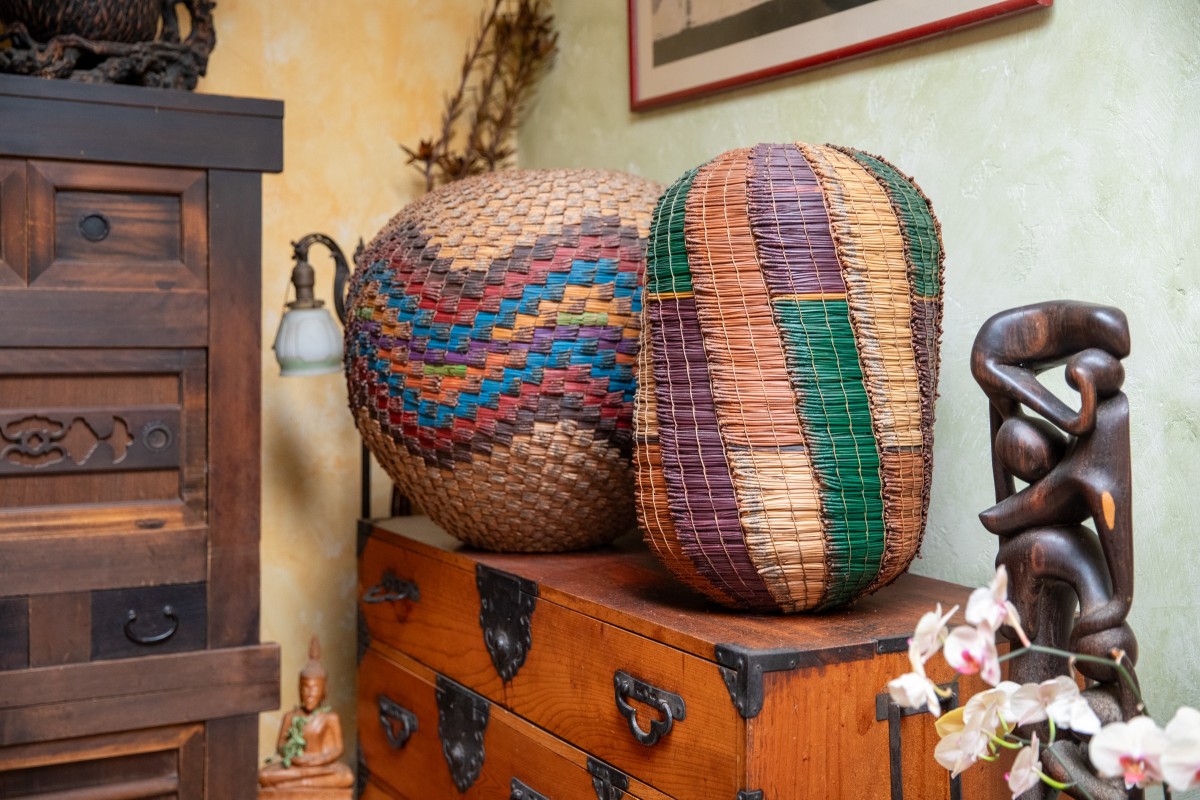 Two large baskets sitting on top of a dresser.