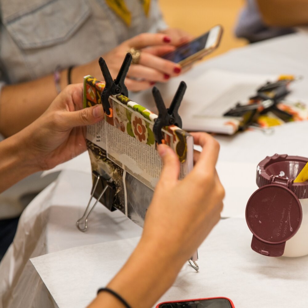 Image of a woman binding a book at an interactive workshop by Mingei International Museum