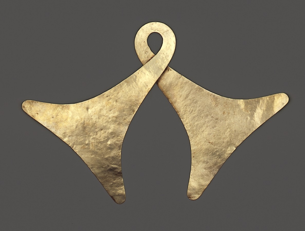 This is a gold body ornament. It is one piece of gold formed into two bell shapes.