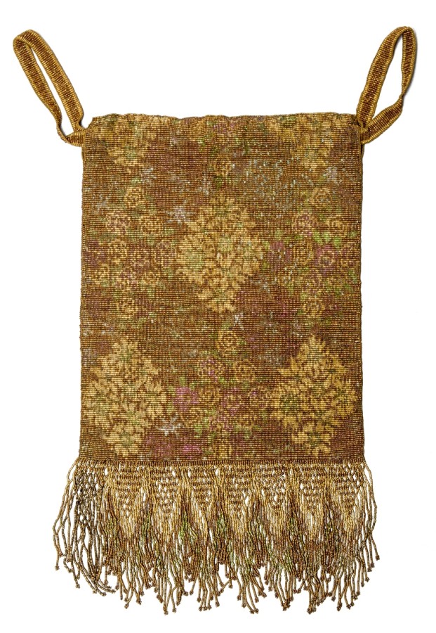 This purse is rectangular with fringe on the bottom.  Its color is yellow and brown, and it has a faint damask pattern..