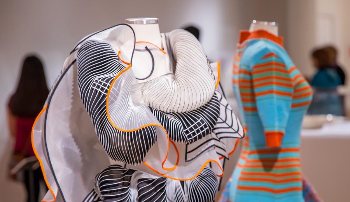 Installation view of Dress Ensemble by Noa Raviv, 2014, pleated silk, white tulle with an adhesive applique of black laser cut polyester, beads, polyamide net. Collection of the artist. L107-41-001 and Recycled textile dress by Dana Cohen, 2015, Ramat Gan, Israel. Collection of the Artist. L107-14-001