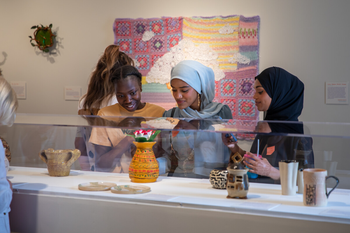 Students admiring works on display at opening reception