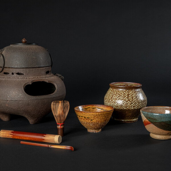 Objects for Japanese Matcha tea from Mingei International Museum's permanent collection.
Image description: Various colorful tea instruments, including tea bowls, a water jar, chasen, matcha scoop, and brazier against a black background.