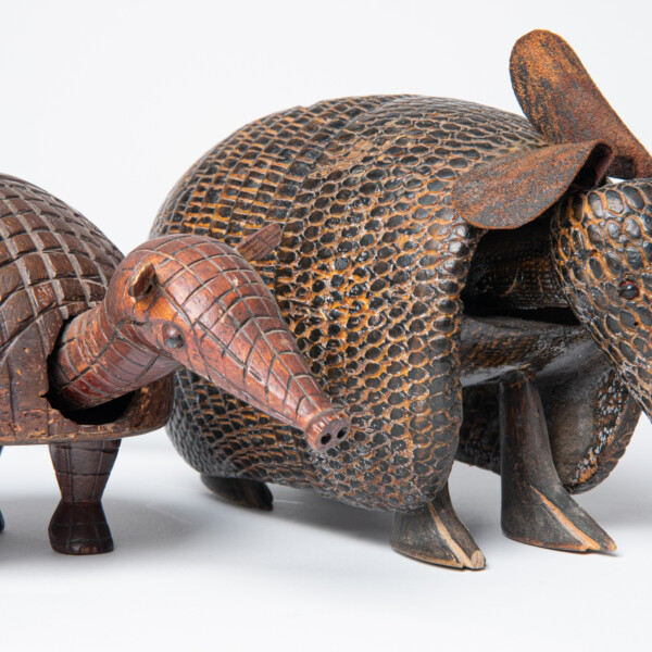 Two armadillo sculptures from Brazil. One made from a coconut shell, and the other carved from wood. 1993-55-035 and 1995-37-001.